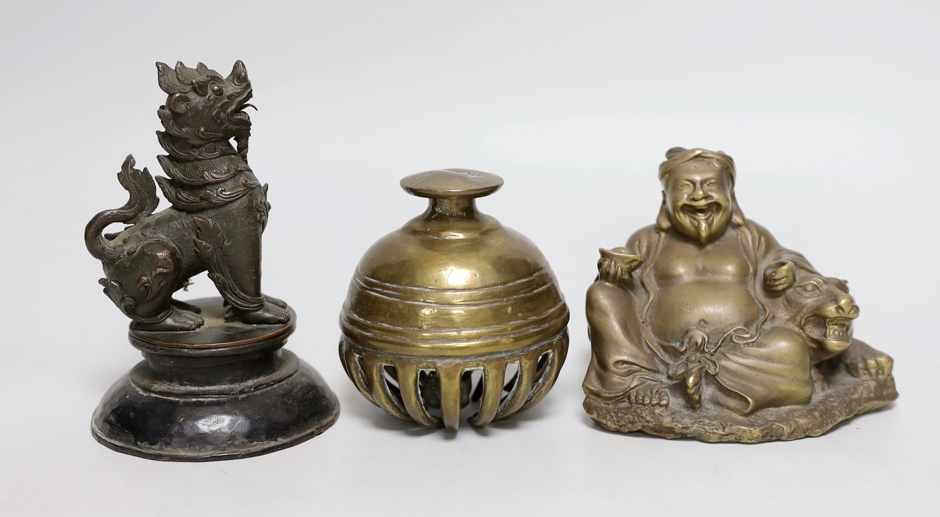 A Chinese bronze seated figure of Budai and tiger together with an Indian elephant bell and a Burmese bronze temple dog